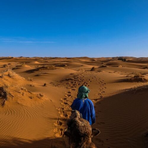 The Wonderful Morocco: A person in a blue robe in a desert with Sahara (Chegaga).