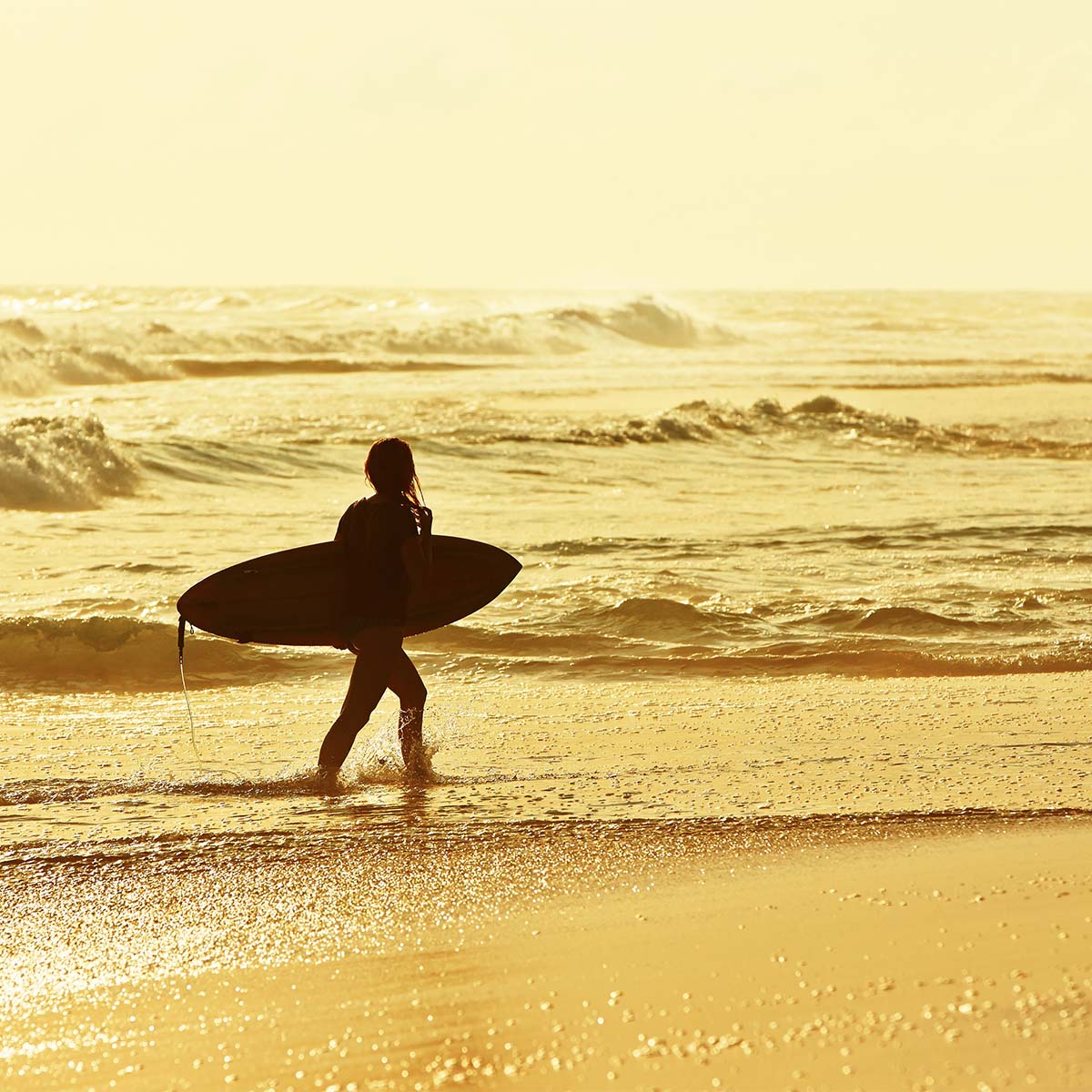 A girl who is about to ride the waves of Morocco with our surf tours - an adventure you won't forget!